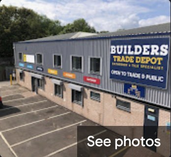 The Builders Trade Depot unit, a grey building with a large navy and yellow sign